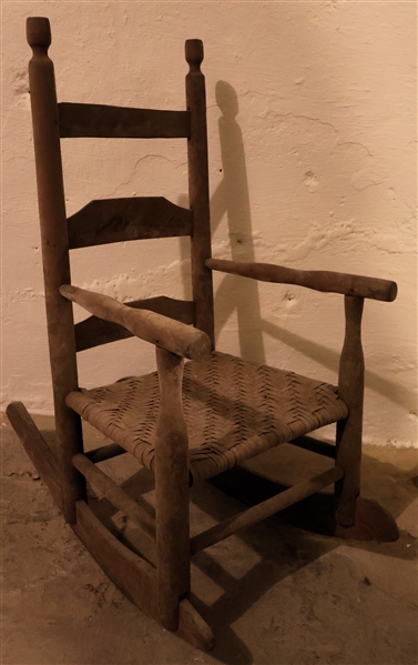 Early Country Primitive Childs Rocking Chair - Original Finish - Good Oak Split Seat - Measures 26 1/2" Tall 14" by 13" 