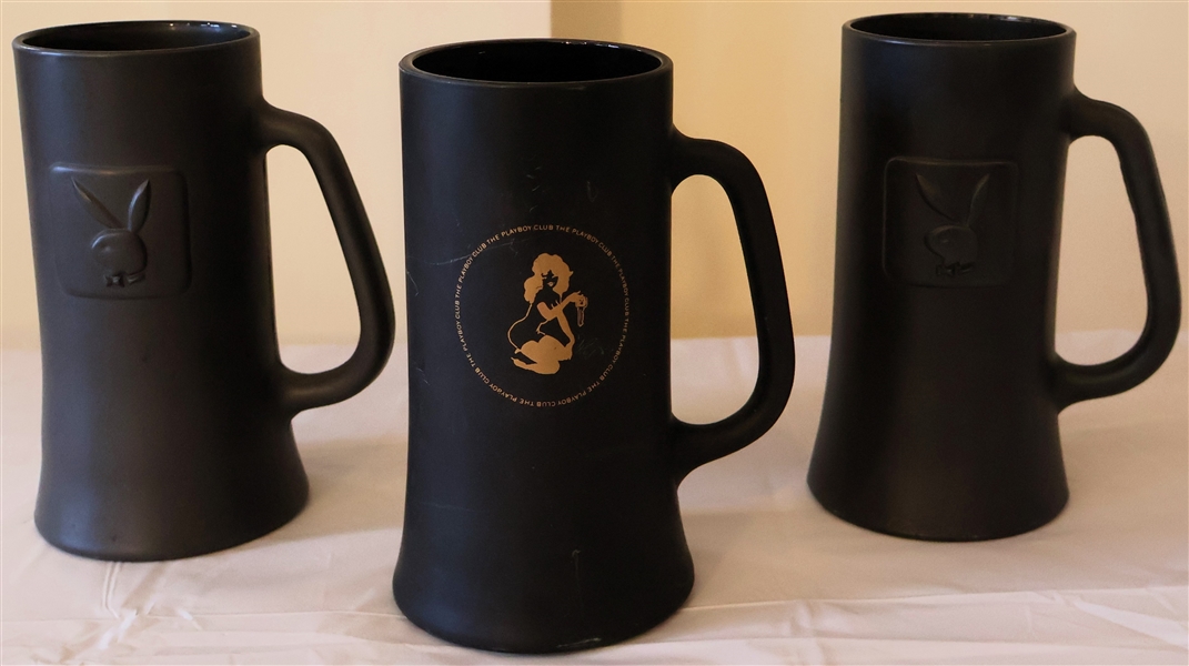 3 - Playboy Mugs - 2 with Embossed Bunny and Playboy on Bottom and Other with Gold Playboy Club Logo - Measures 6 1/2" Tall - One Mug Has Small Chips Along Bottom Edge