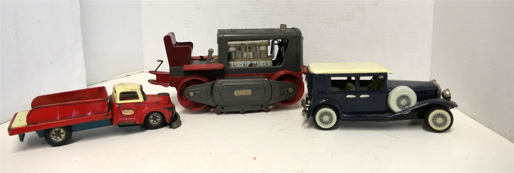 3 Tin Litho Friction Toys - S.S.S. Made in Japan Wreck Truck, Blue Car, and 1200 Crawler Toy Measuring 4 1/2" Tall 9"  Long