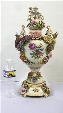 Large Meissen Style Porcelain Lidded Urn with Applied Cherubs, Porcelain Flowers, and Musicians - 3 Piece Construction - Lid, Urn, and Base. Flowers Are in Excellent Condition - Marked Schierholz -...