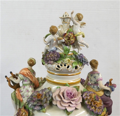 Large Meissen Style Porcelain Lidded Urn with Applied Cherubs, Porcelain Flowers, and Musicians - 3 Piece Construction - Lid, Urn, and Base. Flowers Are in Excellent Condition - Marked Schierholz -...