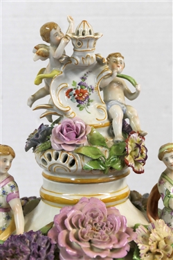 Large Meissen Style Porcelain Lidded Urn with Applied Cherubs, Porcelain Flowers, and Musicians - 3 Piece Construction - Lid, Urn, and Base. Flowers Are in Excellent Condition - Marked Schierholz -...
