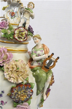 Large Meissen Style Porcelain Lidded Urn with Applied Cherubs, Porcelain Flowers, and Musicians - 3 Piece Construction - Lid, Urn, and Base. Flowers Are in Excellent Condition - Marked Schierholz -...