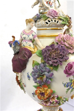 Large Meissen Style Porcelain Lidded Urn with Applied Cherubs, Porcelain Flowers, and Musicians - 3 Piece Construction - Lid, Urn, and Base. Flowers Are in Excellent Condition - Marked Schierholz -...