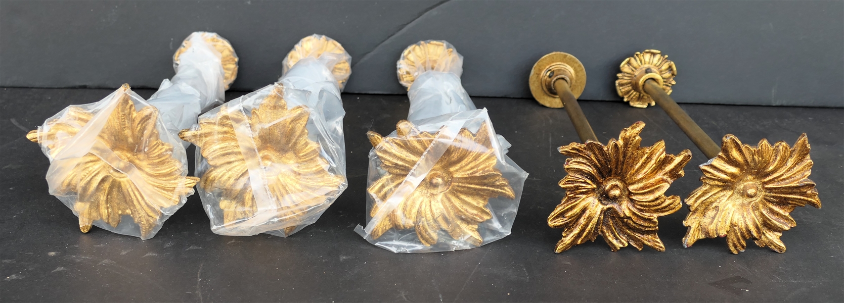 5 Gold Tone Metal Floral Curtain Tie Backs - Appear Unused - Some Still in Original Plastic - One Has Small Broken Area on Petal - Each Measures 8 1/2" Long