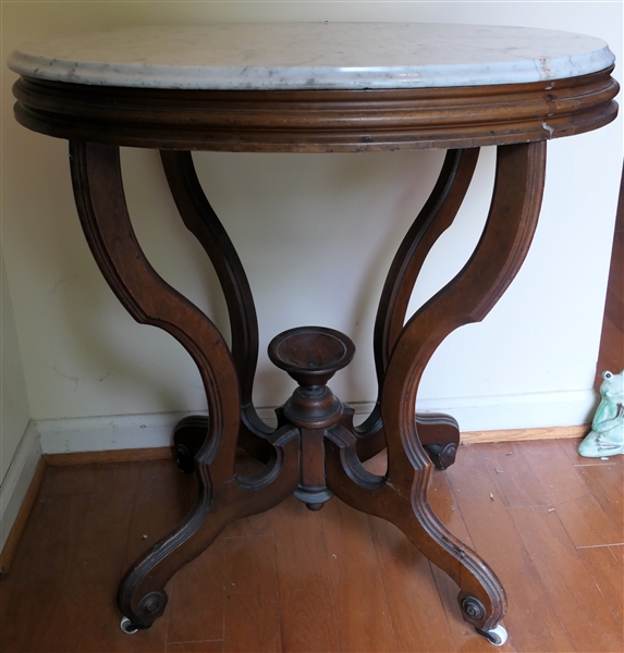 Oval Walnut Victorian Mable Top Table - Porcelain Castors - Table Measures 30" Tall 28" by 20" - Small Crack Along Marble Veining 