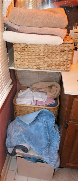 Textile Lot Including Bath and Hand Towels, Sewing Fabric, Storage Baskets, and Wicker Hamper