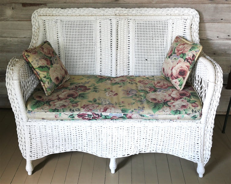 White Painted Wicker Loveseat with Canned Back - Wicker Bottom - Floral Upholstered Cushions - Small Hole in Back of One Seat - Sofa Measures 48" Long