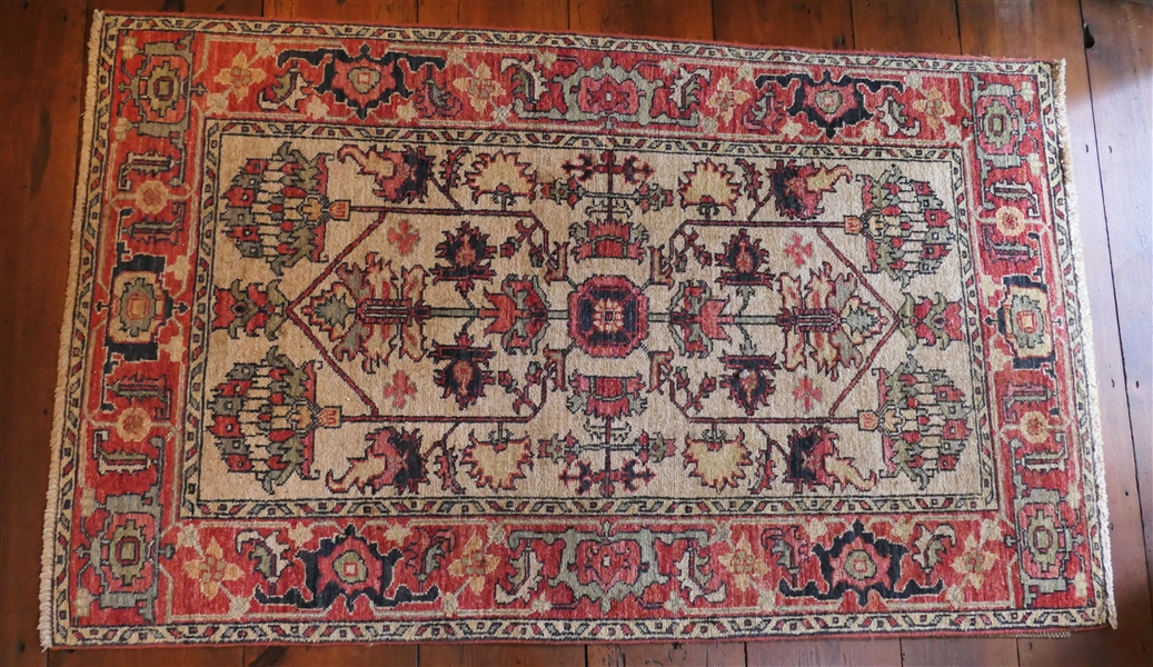 Beautiful Hand Woven Oriental Rug - Cream Background with Coral, Navy, and Green Accents - Measures 63" by 38" 