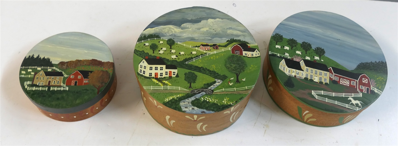 3 - Country Designs by Susan Herrigel - Hand Painted Folk Art Pantry Boxes - Dated 1984 and 1985 - Hand Painted Farm Scenes - Smallest Box Measures 4 1/4" - Largest Measures 6 1/4"