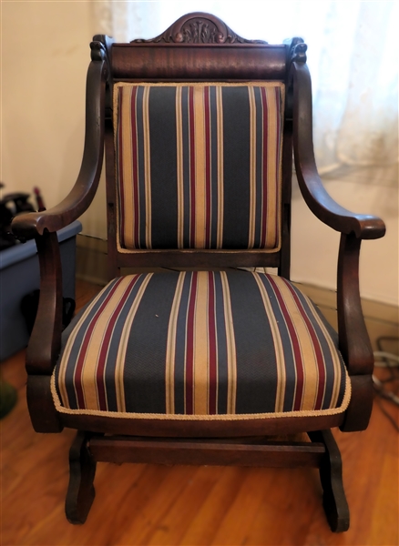 Unusual Lions Head Carpet Rocker with Green, Burgundy, and Gold Striped Upholstery - Flame Mahogany Back Crest - Carved Crest with Scrollwork - Chair Measures 40" Tall 23 1/2" Across 20" Deep