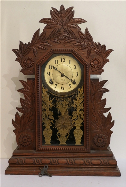 Beautiful Gilbert 8 Day Clock with Key and Fancy Pendulum - Flowers and Leaves on Case - Ornate Gold Flowers and Urns on Door - Clock Measures 23 1/2" tall 15 1/2" by 5" 