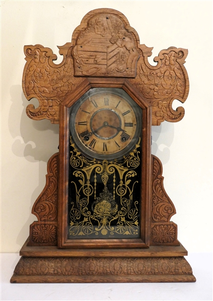 Ingraham Oak Case Mantle Clock -Press Carved Oak Case with People and Well Scene At Top - Fancy Gold Front and Fancy Pendulum - Case Measures 22 1/2" Tall 15" by 5" 