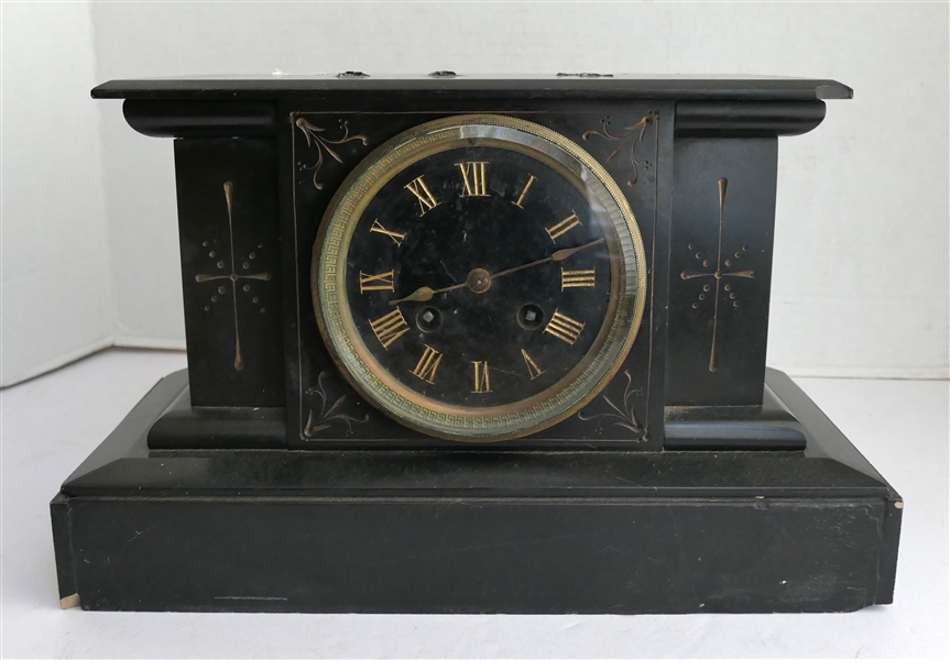 Black Iron Case Mantle Clock on Wood Base - Black Dial with Roman Key Bezel - Roman Numeral Markers - Clock Case Measures 7 3/4" Tall 12" by 6" - Small Chip to Front Left Corner of Wood Base - Some...