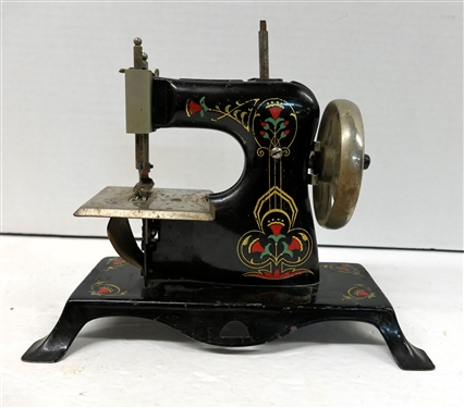 "Foreign" Antique Metal Childs Sewing Machine - Enamel Painted with Red Enamel Flowers - Hand Crank - Machine Measures 6 1/2" tall 