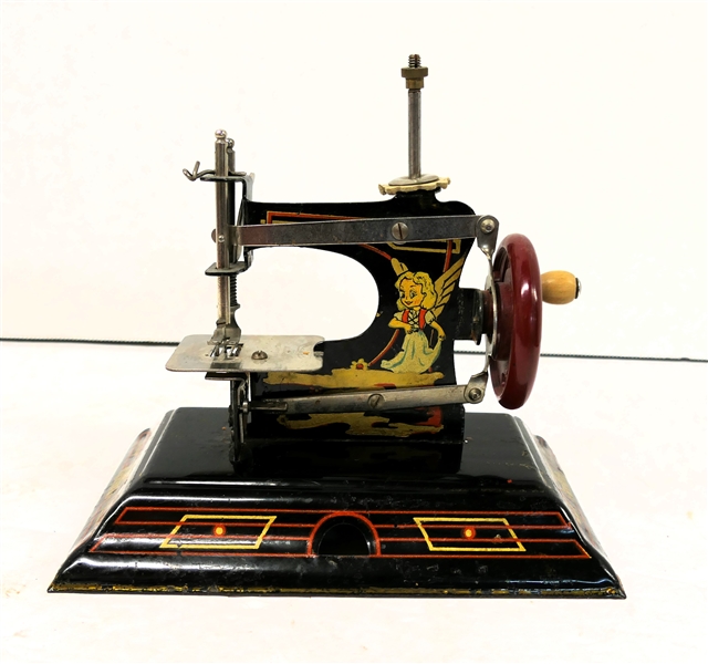 Casige German Childs Sewing Machine - Number 121 - Great Graphics - Fairy on One Side Boy with Dog and Bulls Eye on Other Machine Measures 5" tall 