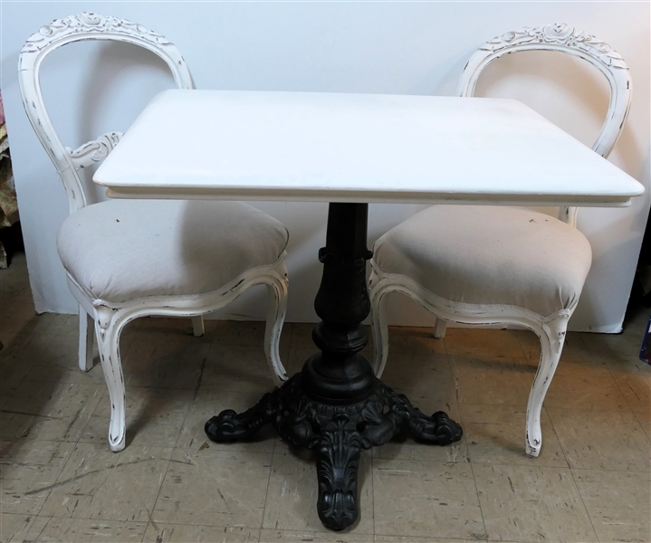 Fine Heavy Iron Based Table with White Painted Wooden Top and Pair of White Painted Balloon Back Side Chairs with Floral Crests - Table Measures 29" tall 34" By 26" -