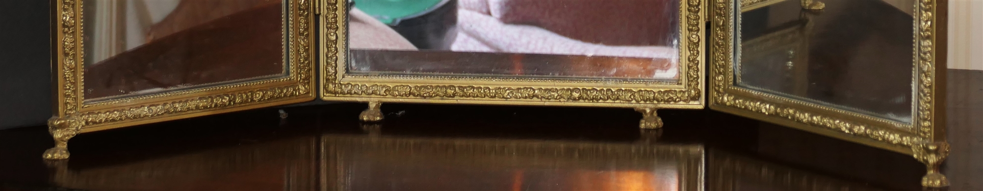 Gold Gilt Tryptic Mirror with Claw Feet - Floral Crest and Swags on Frame - Center Mirror Measures 27 tall 14 Across - Side Mirrors Measure 21 by 10