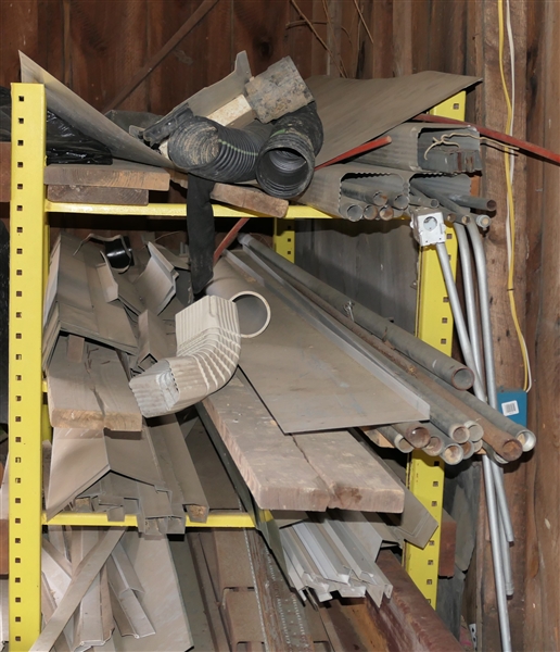 Yellow Shelf with Mixed Lot of Metal and Wood - Boards, Galvanized Pipes, Gutter and Siding Pieces 