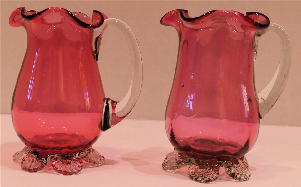 2 Hand Blown Pilgrim Glass Cranberry Pitchers with Clear Applied Feet and Handles - Ribbed Bodies with Fluted Tops - Tallest Measures 4 1/4" Tall 