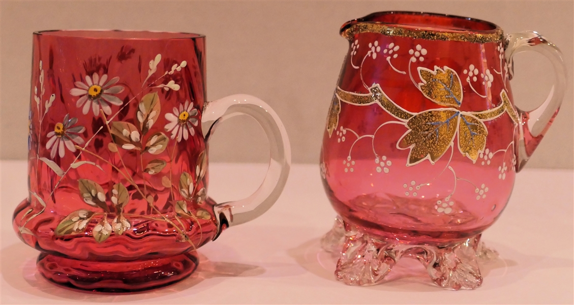 2 Hand Blown Pilgrim Glass Pieces - Cranberry Pitcher with Applied Feet - Enamel Painted Leaves and Flowers with Gold Trim - Clear Applied Handle and Cranberry Mug with Clear Applied Handle -...