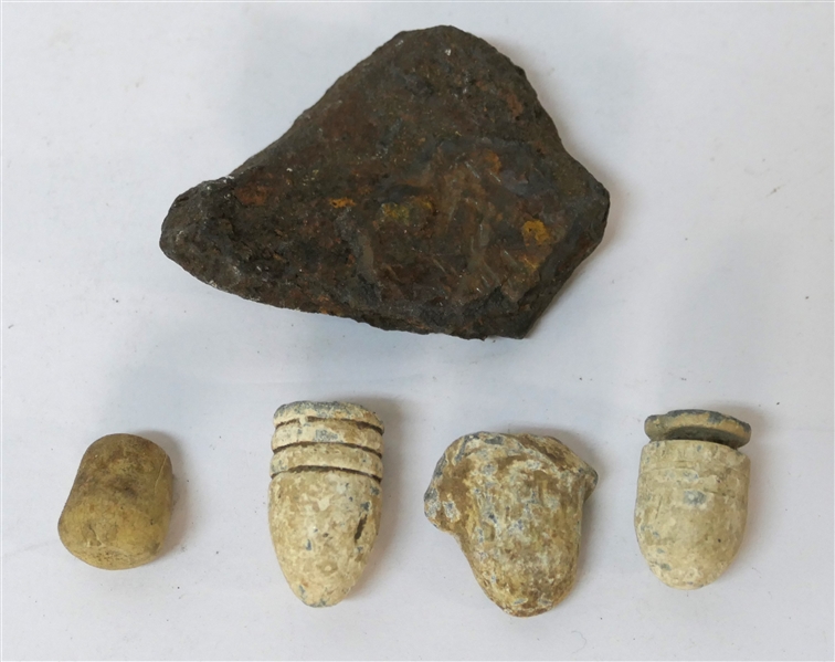 3 Civil War Bullets and Civil War Cannonball Fragment in Fluted Tin Tart Pan - Also with Extraneous Rubber Fragment - Cannonball Piece Measures 2 1/4" by 1 5/8" - Tin Measures 3 1/2"