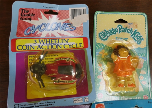 4 New Old Stock Vintage Toys in Original Blister Packs - 1982 Garfield,1984 Cabbage Patch Kids, 1982 Mrs. Pac Man, and 3 Wheelin'' Coin Cycle 