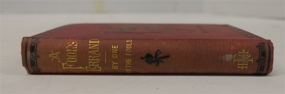 A Fool''s Errand By One of The Fools 1880 - Hard Cover - Paid Stamp Dated March 7th 1880 -New York - Fords, Howard, & Hulbert. 1880 -  Pretty Red Cover with Black Embossed Lettering and Cover Design