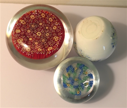 3 Art Glass Paperweights  - Largest with Red Background and Yellow Flowers, White with Multi Colors, and Smallest with Yellow Flowers - Largest measures 2 Tall 3 Across