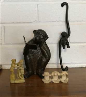 Collection of Monkeys - Bronze Reading a Book, Iron Hanging Monkey, and 2 Sets of Carved Monkeys - Bronze Reading Monkey Measures 5 1/4 Tall
