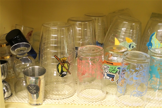 Shelf Lot of Glasses - Flintstones, Tervis Tumblers, Couroc Mid Century, Clear Tumblers, and Assorted Shot Glasses