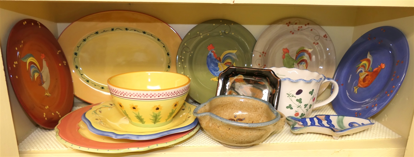 Kitchen Shelf Lot including Pfaltzgraff "Pistoulet" by Jana Koplen, Gourmet Rooster Plates, MA Hadley Fish Spoon Rest, Art Pottery, and Cote Basque Hand Painted Measuring Pitcher