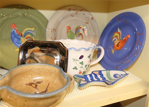 Kitchen Shelf Lot including Pfaltzgraff Pistoulet by Jana Koplen, Gourmet Rooster Plates, MA Hadley Fish Spoon Rest, Art Pottery, and Cote Basque Hand Painted Measuring Pitcher