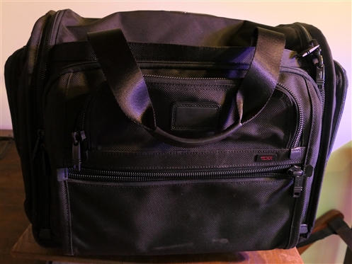 TUMI Rolling Briefcase with Many Zipper Pockets - Retractable Handle - Measures 14" tall 16" by 10" 