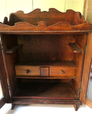 Miniature Cupboard Fitted To Hold Tobacco & Pipes - 2 Drawers Inside - Pipe Holders Line Both Sides - Scalloped Gallery Top and Backsplash and Tops of Doors - Overall Measures 20 Tall 16 1/2 by...
