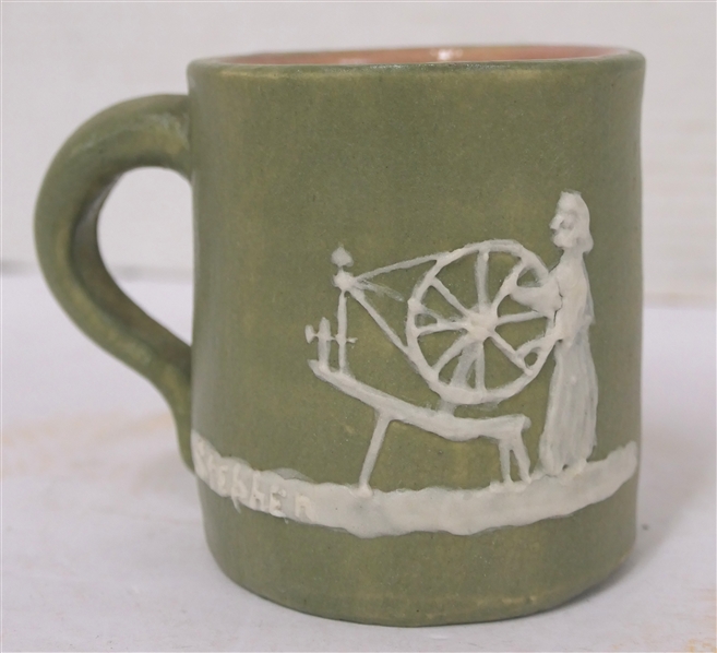 1951 Pisgah Forest Cameo Mug with Woman at Spinning Wheel - Green Glazed Body Pink Glazed Interior - Mug is 3 1/2" Tall - Stamped 1951 Pisgah Forest on Bottom 