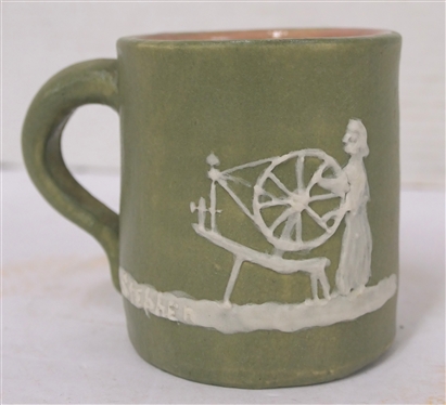 1951 Pisgah Forest Cameo Mug with Woman at Spinning Wheel - Green Glazed Body Pink Glazed Interior - Mug is 3 1/2 Tall - Stamped 1951 Pisgah Forest on Bottom 