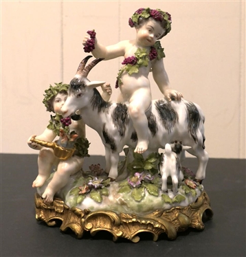 German Porcelain Goat and Putti Figure - Mother and Baby Goat with2 Putti Figures -Ornate Metal Base -  8" Tall 8" Across - Marked 180 SV - Some Minor Broken Petal and Nicks