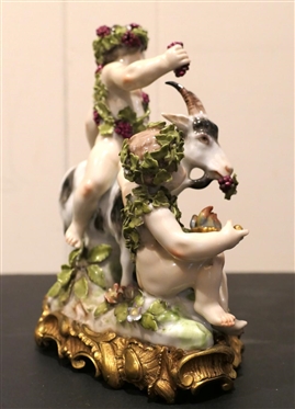 German Porcelain Goat and Putti Figure - Mother and Baby Goat with2 Putti Figures -Ornate Metal Base -  8 Tall 8 Across - Marked 180 SV - Some Minor Broken Petal and Nicks