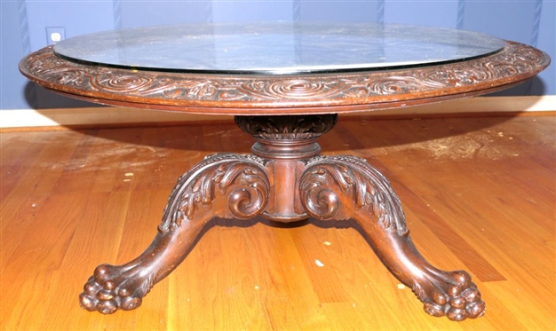 Ornate Round Mahogany Coffee Table with Heavily Carved Pedestal Base and Claw Feet - Carved Border Around Table Top with Protective Glass Top - Table is 18 1/2 Tall 38 Wide 