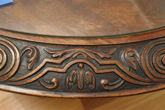 Ornate Round Mahogany Coffee Table with Heavily Carved Pedestal Base and Claw Feet - Carved Border Around Table Top with Protective Glass Top - Table is 18 1/2 Tall 38 Wide 