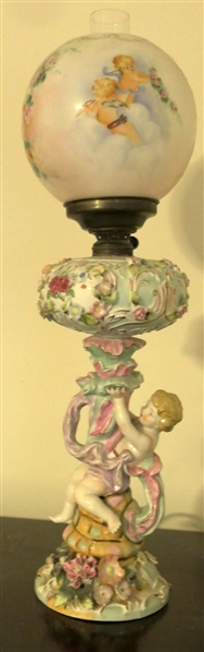 Dresden / Meissen Cherub Lamp with Porcelain Base - Cherub on Pedestal - Applied Porcelain Flowers Overall - Hand Painted Cherubs on Glass Shade - Lamp Has Been Electrified - Measures 20" tall -...