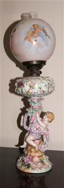 Dresden / Meissen Cherub Lamp with Porcelain Base - Cherub on Pedestal - Applied Porcelain Flowers Overall - Hand Painted Cherubs on Glass Shade - Lamp Has Been Electrified - Measures 20 tall -...