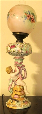 Dresden / Meissen Cherub Lamp with Porcelain Base - Cherub on Pedestal - Applied Porcelain Flowers Overall - Hand Painted Cherubs on Glass Shade - Lamp Has Been Electrified - Measures 20 tall -...