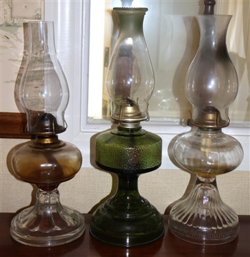 Trio of Oil Lamps - Clear Ribbed Lamp, Olive Green, and Slick Oil Lamp with Ribbed Base - All with Glass Chimneys 